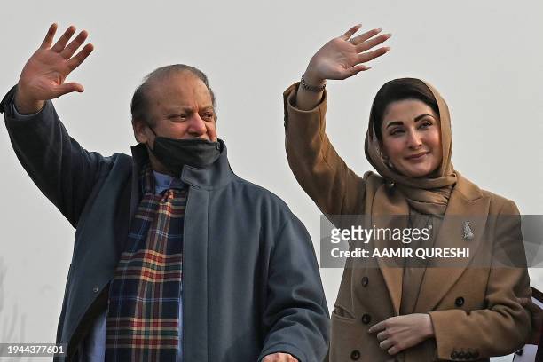 Pakistan's former Prime Minister and leader of Pakistan Muslim League Nawaz party Nawaz Sharif and his daughter Maryam Nawaz wave to their supporters...