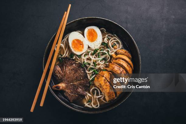 ramen bowl on black background - chinesische küche stock-fotos und bilder