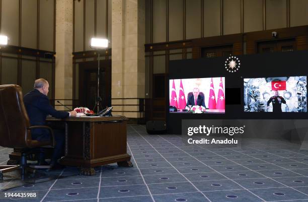 Turkish President Recep Tayyip Erdogan speaks with the first Turkish space traveler, Alper Gezeravci, currently conducting scientific researches on...