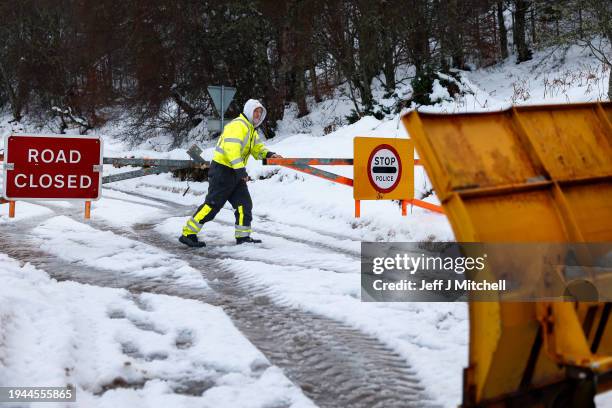 Plough man opens the snow gates on the A836 Scourie road on January 19, 2024 in Ardgay, Scotland. A yellow weather alert persists for many in...