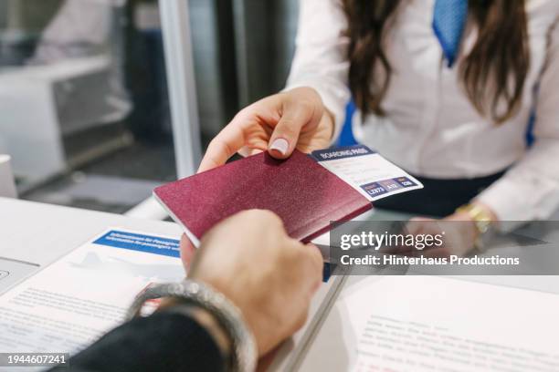 a man checks in for his flight - german passports stock-fotos und bilder