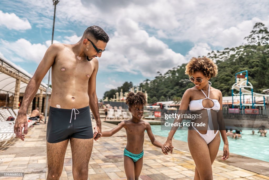 Family walking and talking with son at water park