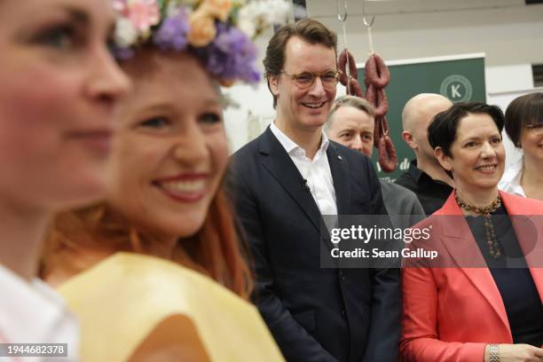 North Rhine-Westphalia Premier Hendrik Wuest poses with participants while touring the North Rhine-Westphalia hall at the Green Week agricultural...