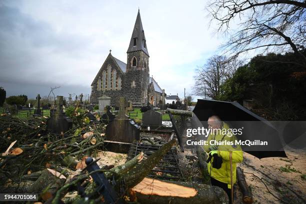 Local resident looks at the damage caused by a fallen tree that fell into the graveyard at St Josephs Church on January 22, 2024 in Glenavy, Northern...