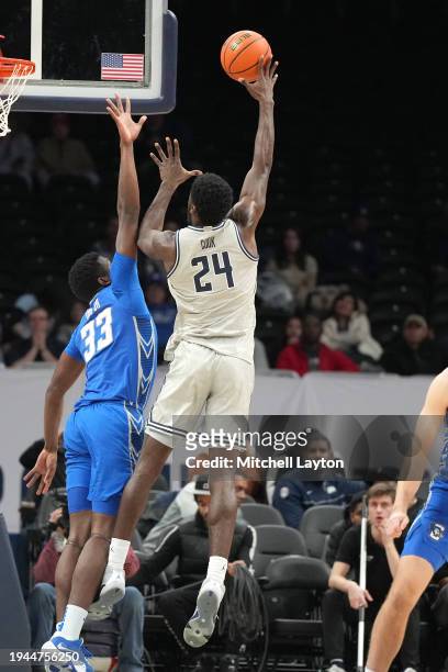 Supreme Cook of the Georgetown Hoyas takes a shot over Fredrick King of the Creighton Bluejays during a college basketball game at the Capital One...