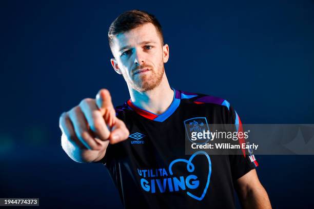 Rhys Healey poses for photographs after signing for Huddersfield Town at the Millers Oil High Performance Complex on January 19, 2024 in...