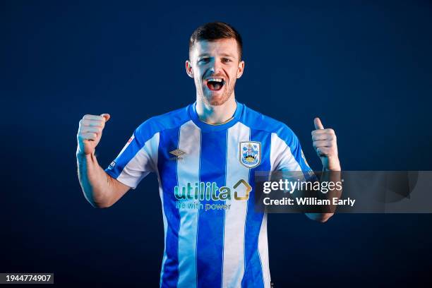 Rhys Healey poses for photographs after signing for Huddersfield Town at the Millers Oil High Performance Complex on January 19, 2024 in...