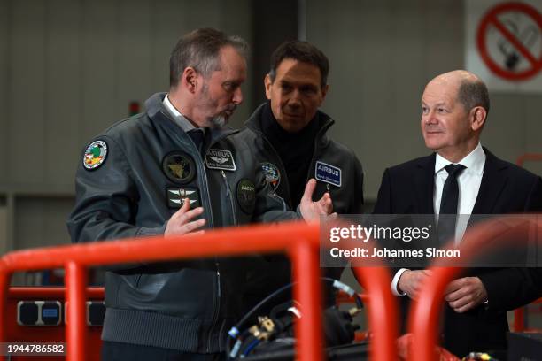 German Chancellor Olaf Scholz , beside of Mike Schoellhorn and Rene Obermann of Airbus visits the construction hall of the Eurofighter Typhoon at the...