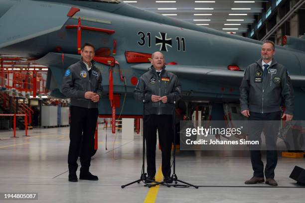 German Chancellor Olaf Scholz , beside of Rene Obermann and Mike Schoellhorn of Airbus addresses media after visiting the construction hall of the...