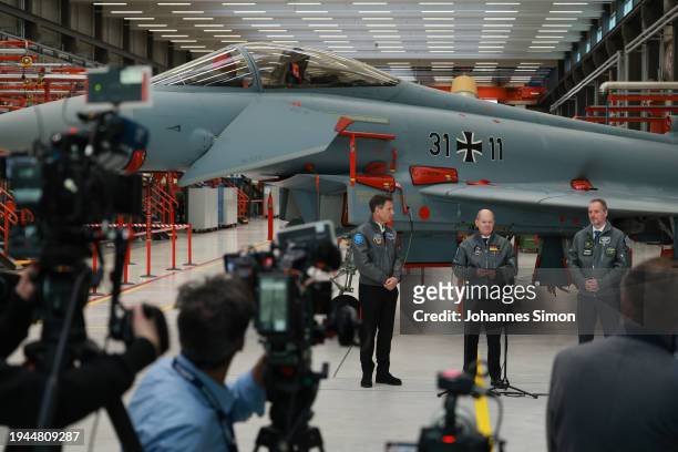 German Chancellor Olaf Scholz , beside of Rene Obermann and Mike Schoellhorn of Airbus addresses media after visiting the construction hall of the...