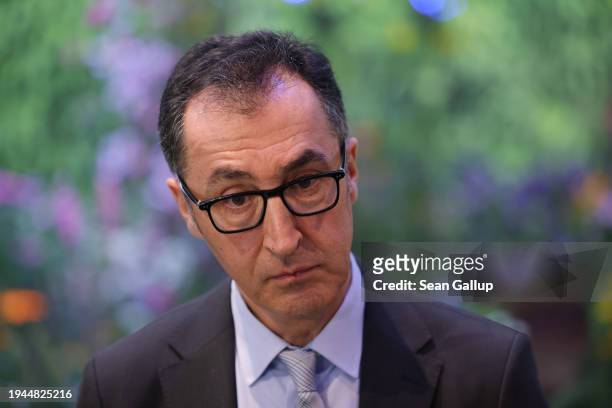 German Federal Agriculture Minister Cem Oezdemir speaks to journalists while touring the Green Week agricultural trade fair on its opening day on...