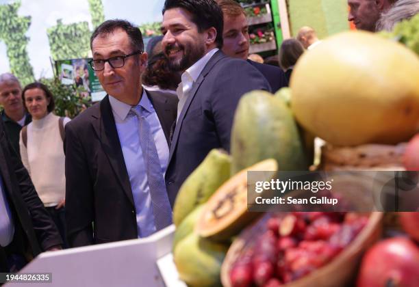 German Federal Agriculture Minister Cem Oezdemir poses for a quick photo with a fan while touring the Green Week agricultural trade fair on its...