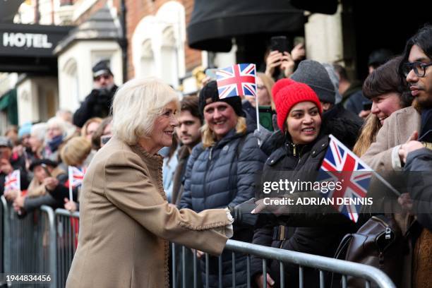 Britain's Queen Camilla meets with well-wishers during a visit to Deacon & Son Jewellers in Swindon, western England on January 22 as the company...