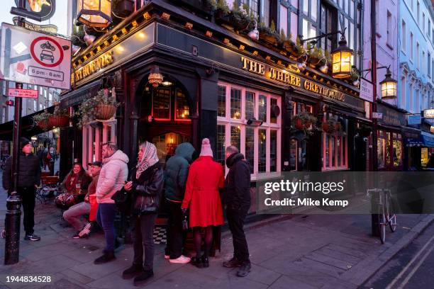 People outside The Three Greyhounds pub on the corner of Greek Street and Old Compton Street in Soho on 19th January 2024 in London, United Kingdom....