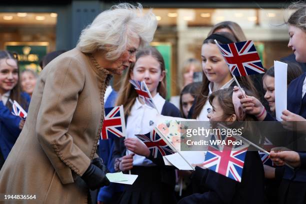 Britain's Queen Camilla receives get well cards for Britain's King Charles III during a visit to Deacon & Son Jewellers, as the company celebrates...