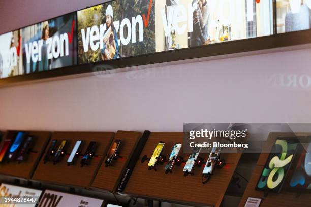 Phones inside a Verizon store in New York, US, on Friday, Jan. 12, 2024. Verizon Communications Inc. Is scheduled to release earnings figures on...