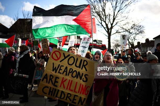 People chant slogans, hold placards and wave Palestinian flags as they take part in a Palestine Solidarity Campaign demonstration outside Twickenham...