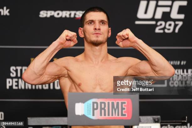 Movsar Evloev of Russia poses on the scale during the UFC 297 official weigh-in at the Marriott Downtown at CF Eaton Centre on January 19, 2024 in...