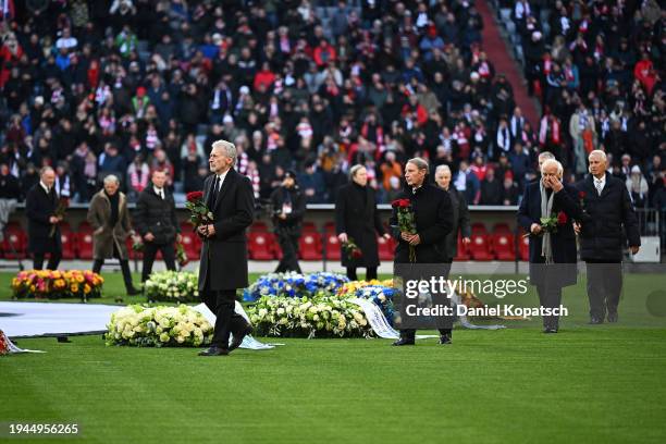 Paul Breiter and Berti Vogts carry flowers during a memorial service for the late Franz Beckenbauer at Allianz Arena on January 19, 2024 in Munich,...