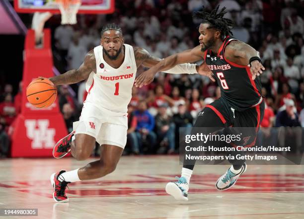 Houston Cougars guard Jamal Shead drives the ball against Texas Tech Red Raiders guard Joe Toussaint during the second half of a mens NCAA basketball...