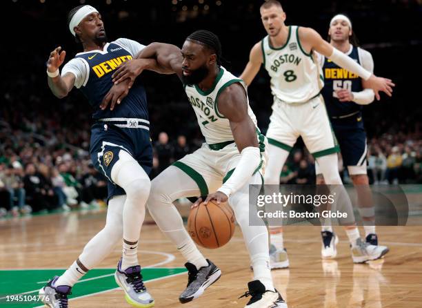 Boston, MA Boston Celtics SG Jaylen Brown attempts to ward off Denver Nuggets SF Kentavious Caldwell-Pope in the first quarter. The Celtics lost to...