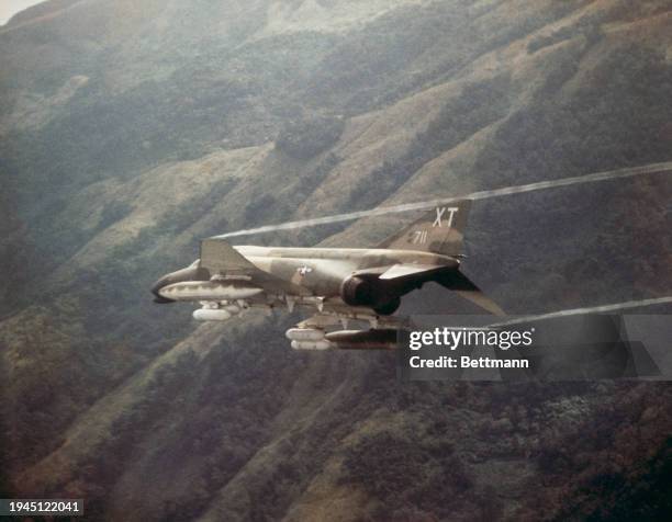 Air Force McDonnell Douglas F-4 Phantom fighter plane diving for a target in North Vietnam, August 31st 1967.