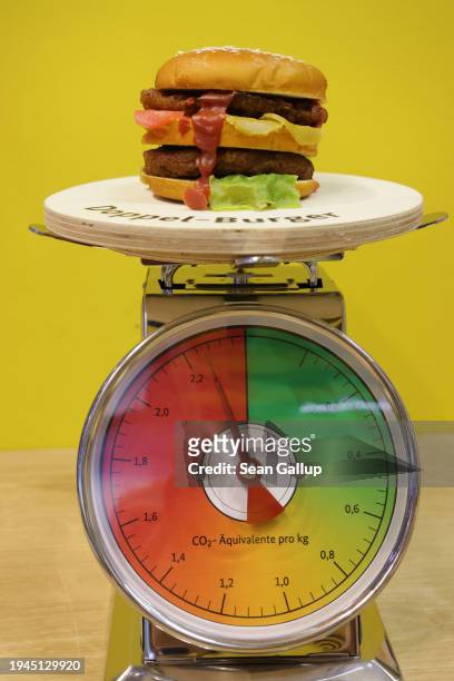 Display with a scale illustrates the climate impact and CO2 emissions of a double patty beef burger at the stand of Germany's Federal Ministry of...