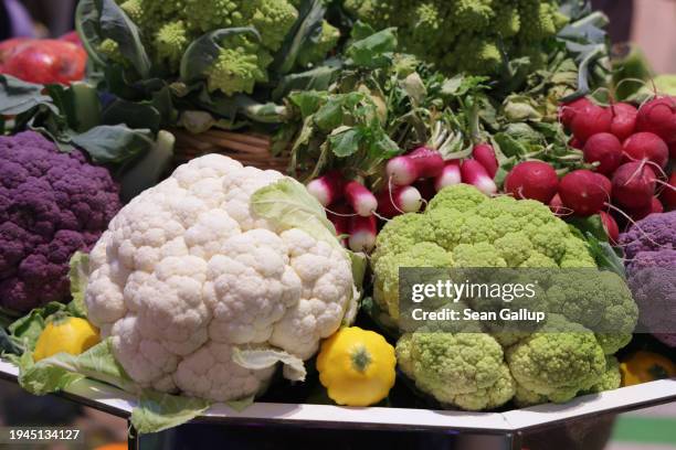 Vegetables, including cauliflower, radishes and squash, lie on display at the Green Week agricultural trade fair on its opening day on January 19,...