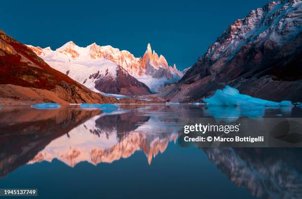 cerro torre reflecting in laguna torre, patagonia argentina - nationalpark bildbanksfoton och bilder