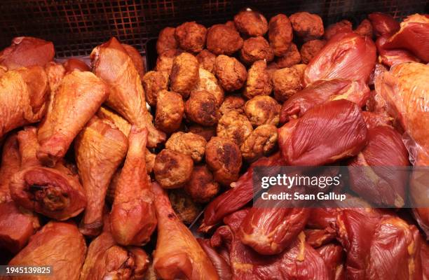 Cured meat lies on display at a meats products stand at the Green Week agricultural trade fair on its opening day on January 19, 2024 in Berlin,...