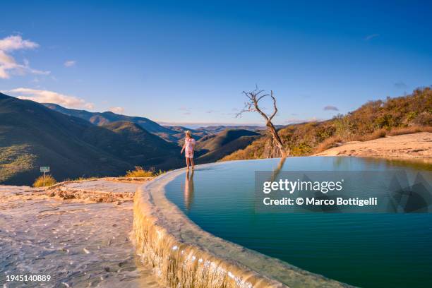 woman looking at view at hierve el agua, oaxaca, mexico - oaxaca fotografías e imágenes de stock