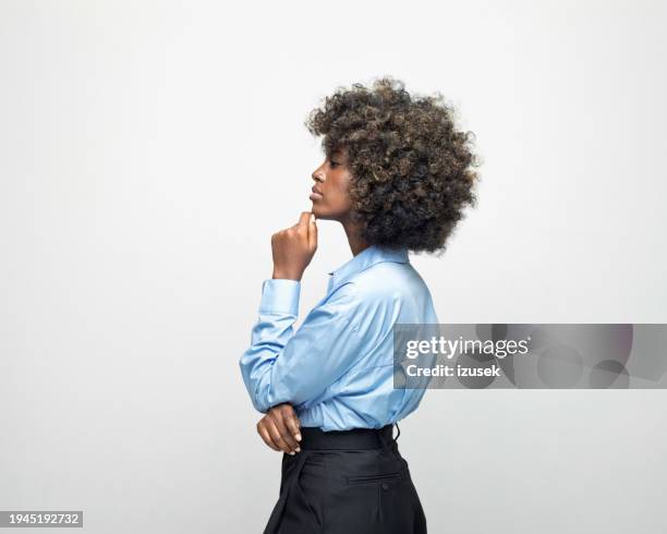 side view of a thoughtful young businesswoman - blank black shirt stock pictures, royalty-free photos & images