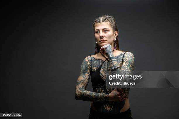 tattooed girl studio portrait on gray background - belly button piercing stock pictures, royalty-free photos & images