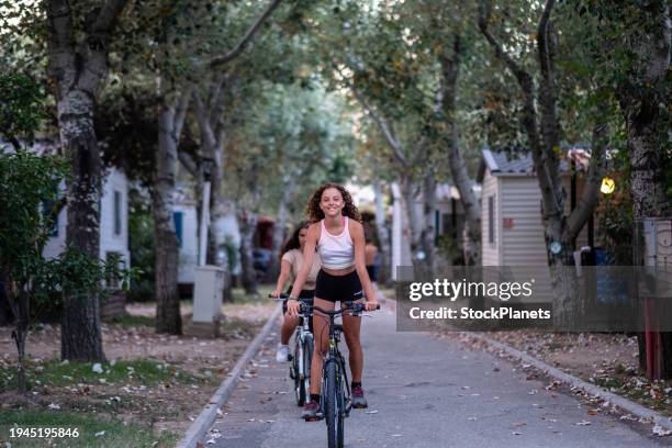 girls ride bikes - bangaló imagens e fotografias de stock