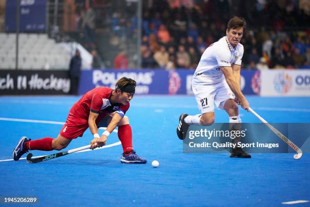 Nam Yong Lee of Korea competes for the ball with Tom Boon of Belgium during the FIH Men's Olympic Hockey Qualifying Tournament semi-final match...