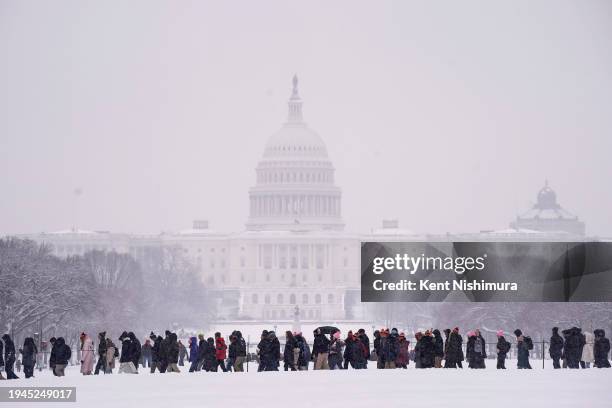 People attend the annual March for Life rally on the National Mall on January 19, 2024 in Washington, DC. Amidst snow and freezing temperatures...