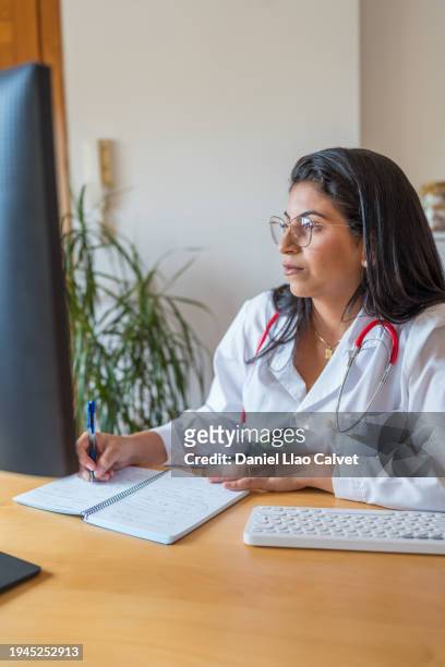 female doctor taking note - casa calvet stock pictures, royalty-free photos & images