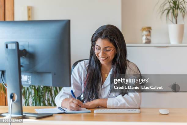 female doctor writing prescription for medicine at her desk - casa calvet stock pictures, royalty-free photos & images