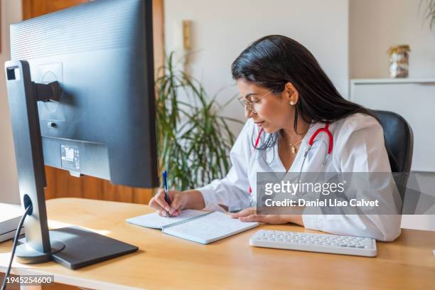 female doctor working from home - casa calvet stock pictures, royalty-free photos & images