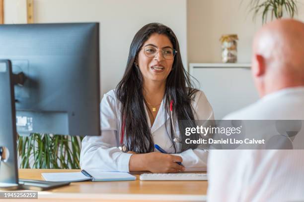 young female doctor with patient - casa calvet stock pictures, royalty-free photos & images