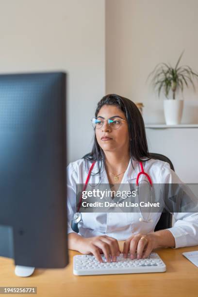 female doctor using computer - casa calvet stock pictures, royalty-free photos & images