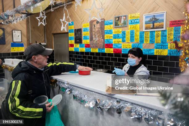 An elderly man receives a free lunch in the volunteer ‘FuMi Caffe’ cafe on December 1, 2023 in Kharkiv, Ukraine. A Japanese volunteer Fuminori...