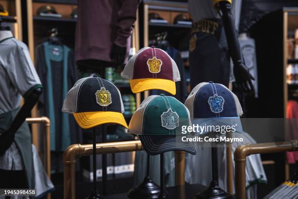 Caps with the logos of the houses of Hogwarts: Gryffindor, Slytherin, Ravenclaw and Hufflepuff are seen in the store of the "Harry Potter The...