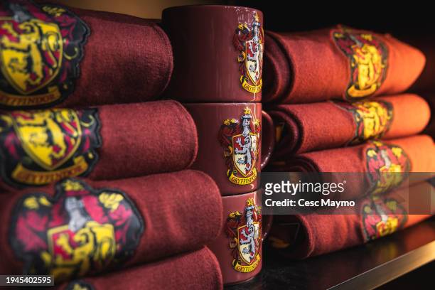 The Gryffindor logo is seen on cups and scarfs, in the store of the "Harry Potter The Exhibition" on January 19, 2024 in Barcelona, Spain.