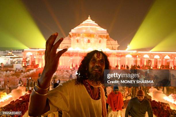 Hindu devotees gather near the illuminated Ram temple following its consecration ceremony in Ayodhya in India's Uttar Pradesh state on January 22,...