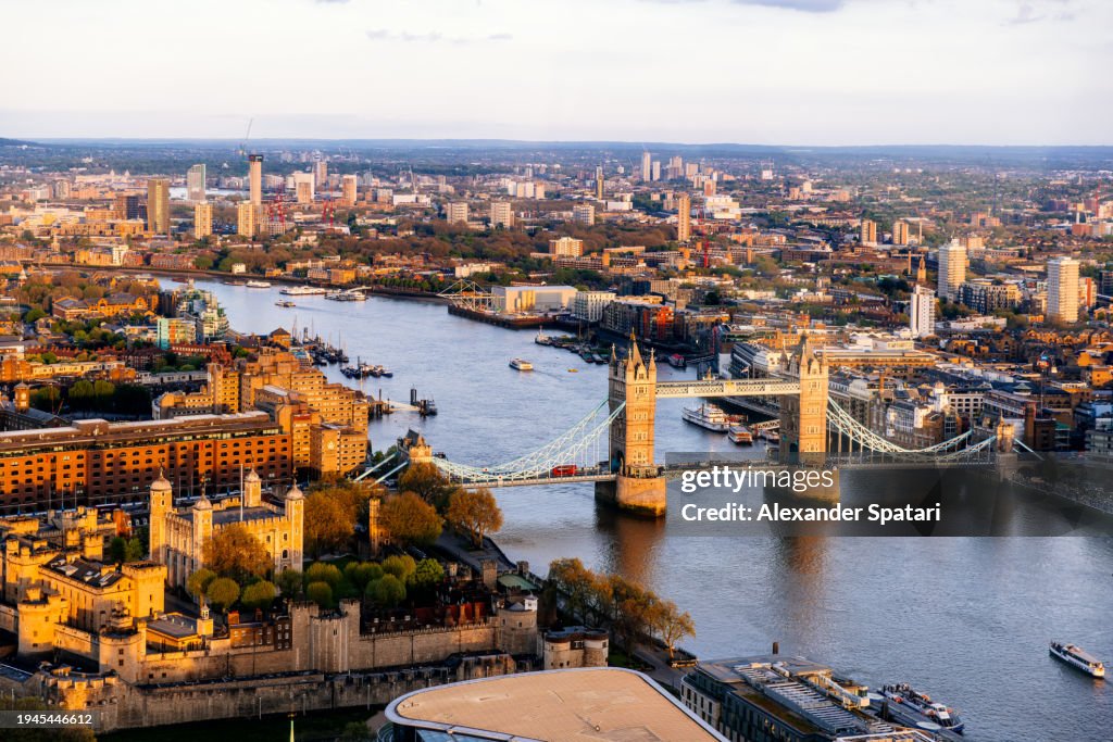 Aerial view of London cityscape, with Tower of London and Tower Bridge at sunset, UK