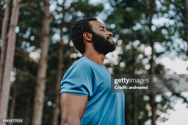 portrait of a man breathing fresh air in nature - vapor da respiração imagens e fotografias de stock