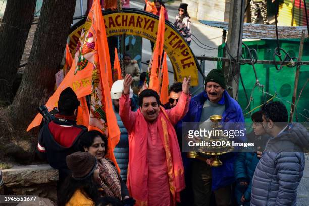 Hindu devotees shout religious slogans as they arrive to perform rituals at the Shankaracharya temple on the occasion of Ayodhya Ram temple's...