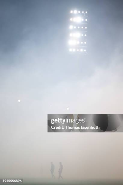 Players of Aue and Essen stay in fog after fans start pyrotechnics during the 3. Liga match between Erzgebirge Aue and Rot-Weiss Essen at...