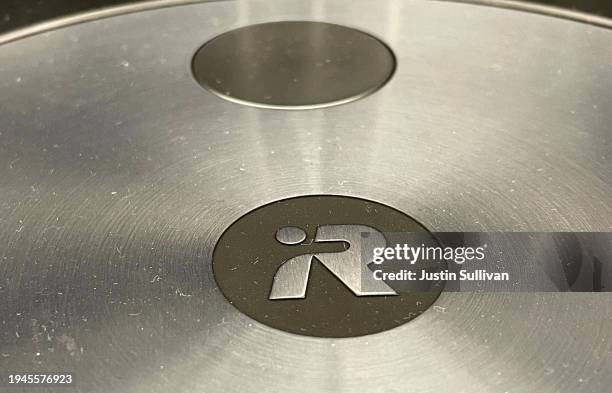 The iRobot logo is displayed on a Roomba vacuum at Best Buy store on January 19, 2024 in San Rafael, California. The European Commission, the EU’s...